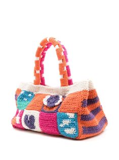 a crocheted handbag with an orange, pink and blue design on it