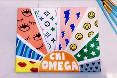 an assortment of colorful stickers with the words chi omega on them next to pens and pencils