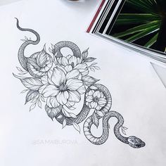 a snake and flowers tattoo design on paper