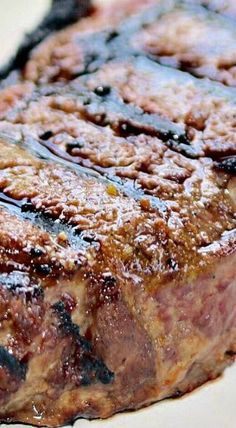 a piece of steak on a white plate