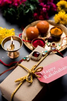 a gift wrapped in brown paper sitting on top of a table next to other items