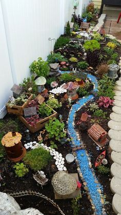 a small garden is shown in the middle of an outdoor area with rocks and plants