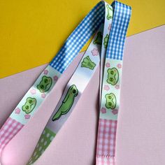 two lanyards with pepo the frog designs on them