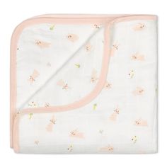 a white blanket with pink trim and an animal print on the bottom is folded up