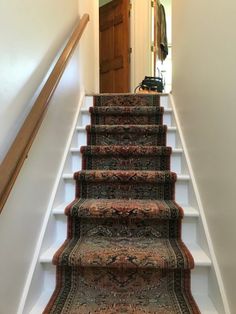 a carpeted staircase leading up to a door