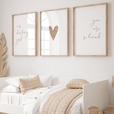 a bedroom with two framed pictures above the bed