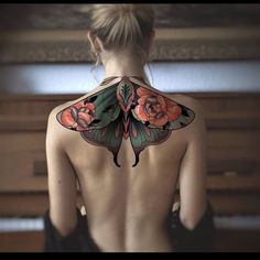 the back of a woman's body with tattoos on her upper and lower half