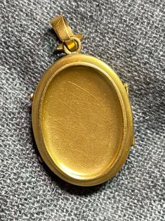 ". This beautiful oval locket has that gorgeous Victorian \"bloom\" to the gold that cannot be duplicated. It really can't be duplicated because the process has been illegal for almost 100 years now. The bale is an abstract fleur de lis shape. This locket is plated in 18k, thick enough to test 18k on the electronic tester! This locket does not have removable photo rings, but a printed picture could be carefully pressed in so it sits under the edge. I just print from my home printer on photo pape Luxury Oval Locket Necklace As Gift, Luxury Oval Jewelry For Keepsake, Luxury Oval Locket Jewelry, Collectible Yellow Gold Jewelry With Oval Cabochon, Vintage Oval Locket Necklace In 14k Gold, Elegant Gold Cameo Locket Necklace, Luxury Yellow Gold Oval Locket Necklace, Collectible Gold Oval Link Jewelry, Antique Oval Jewelry With Polished Finish