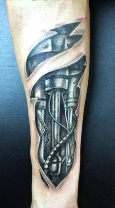 a black and white tattoo on the leg of a man's leg with an image of a machine