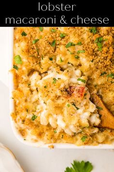 lobster macaroni and cheese in a casserole dish with parsley on the side