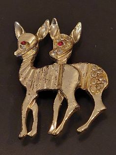 A cute pair of Reindeer crafted in a gold base metal pin. They have Amber eyes and one has crystal rhinestone additions. All stones are present and the pin is in good working order. Light wear on on front and rear finish but has a nice vintage patina. Any questions please ask. Ships for $3.95 in 1 business day as first class parcel for quick delivery. Have a great day and thanks for looking! Check out over one hundred additional items in our shop. Honeybrookbarnfinds.etsy.com Steampunk Owls, Reindeer Craft, Amber Eyes, Rhinestone Eyes, Vintage Trifari, Bird Brooch, Wild Animal, Metal Pins, Glass Eyes