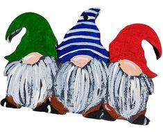 three gnomes with hats and scarves painted on them