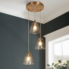 three lights hanging from a ceiling in a room