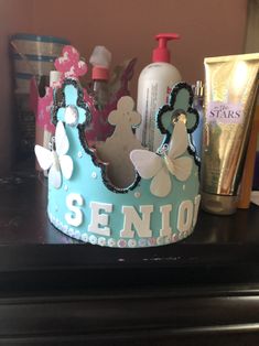 a blue crown sitting on top of a table next to a bottle of lotion