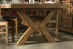 a wooden table with chairs around it