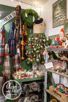 a room filled with lots of different types of christmas decorations and wreaths on display