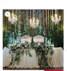 the table is decorated with greenery and candles