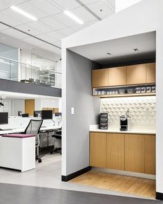 an empty office with desks and computers