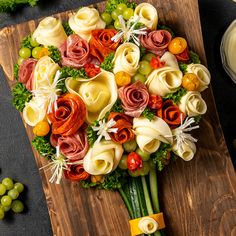 a bouquet of flowers sitting on top of a wooden cutting board