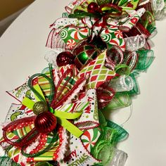 a christmas wreath made out of ribbons and bows