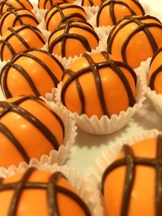 chocolate covered oranges are lined up on a white tray and ready to be eaten