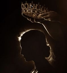 the silhouette of a woman with a crown on her head is shown in front of a dark background