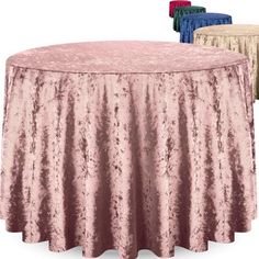 three different colors of tablecloths sitting on top of a round table with two tables in the background