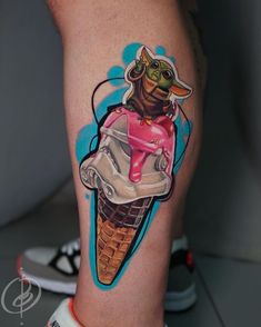 an ice cream cone with a cat in it on someone's leg that is wearing sneakers