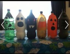 six halloween bottles are lined up on a table