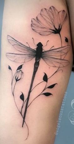 a woman's thigh with flowers and a dragonfly on it