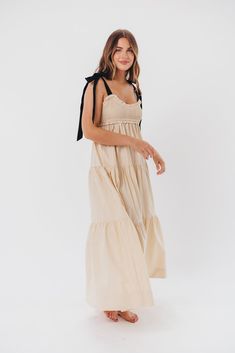 This dress is the perfect blend of femininity and contemporary comfort - meet the Amber Maxi Dress, a sweet and effortless gown for your next special event. We love its unique smocked bodice with a charming sweetheart neckline, plus self-tie shoulder straps in a sleek black hue. Pair this beauty with heels or slides and prepare yourself for the compliments! Available in two colorways. FIT: Runs true to size. Bodice is smocked and stretchy, but empire waist gives it a fitted structure that can be restricting for larger chests. Size up if you are between sizes. MATERIAL: GARMENT DETAILS: Lightweight maxi dress with empire-waisted silhouette and self-tie shoulder straps in contrasting color. Features a smocked bodice with sweetheart neckline, and a full, multi-tiered skirt. SIZE GUIDE: XS (0- Chic Smocked Bodice Maxi Dress For Brunch, Spring Smocked Dress With Fitted Bodice And Ruffles, Spring Smocked Dress With Ruffles And Fitted Bodice, Casual Smocked Maxi Dress With Ruched Bodice, Chic Midi Dress With Smocked Bodice And Ruffled Straps, Chic Flowy Smocked Dress With Ruffled Straps, Chic Smocked Dress With Ruffled Straps, Chic Smocked Dress With Flowy Fit And Ruffled Straps, Chic Smocked Dress With Ruched Bodice For Vacation