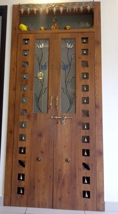 two wooden doors with glass inserts on them