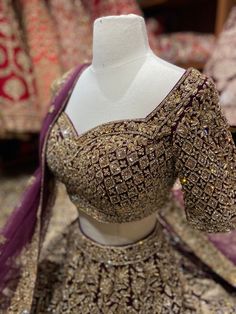 This wine red landed with multi-hued floral and birds embroideries and sequin, beads, zari and thread work lehenga with cut dana embroidery. Teamed up with similarly embroidered blouse and net dupatta. This wine red lehenga struck a chord with our voguish sensibilities and would satiate your bridal desires too. Fabric: Velvet Custom designed according to client measurements and color preference. Production and delivery time is 120 days! Elegant Purple Dabka Embroidered Fabric, Elegant Purple Fabric With Dabka Embroidery, Intricate Embroidery Party Wear Fabric For Festivals, Burgundy Anarkali Sets For Wedding, Party Wear Embroidered Chinon Choli, Party Wear Embroidered Choli In Chinon, Bollywood Style Burgundy Traditional Wear For Wedding, Elegant Red Lehenga With Handwork, Festive Purple Choli With Dabka Work