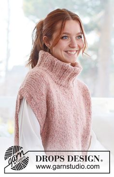 a woman wearing a pink knitted sweater and white shirt with the words drops design on it