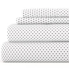 four white sheets with black polka dots on them