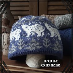 a blue and white knitted hat sitting on top of a wooden table