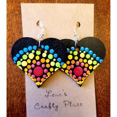 two heart shaped earrings with colorful dots on them