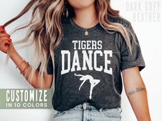 This personalized school dance team shirt is the perfect tee to rep your school or dancer! Our Bella+Canvas tees have that light and vintage feel. ♥ 》 》HOW TO ORDER 《 《 * Select size + color from the drop down menus * Type your custom mascot in the personalization box. * Add to cart + place order ♥ * Your shirt is now in production & will be ready to ship in 1-3 days! 》 》SIZING 《 《 These are soft men's-cut shirts. Although these are unisex, I would NOT downsize. Check out the fit guide in the im Fitted School Spirit T-shirt With Letter Print, Fitted T-shirt With Name Print For Dance Class, Fitted T-shirt With Letter Print For School Spirit, Fitted Custom Print T-shirt For Dance Class, Fitted School Spirit T-shirt For College, Fitted College T-shirt With School Spirit, Fitted Team Spirit T-shirt With Custom Print, Fitted Custom Print Team Spirit T-shirt, Fitted Custom Print T-shirt For Team Spirit