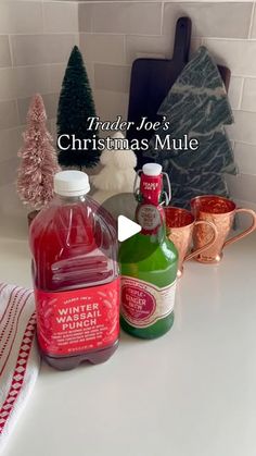 a bottle of wine sitting on top of a counter next to other bottles and cups