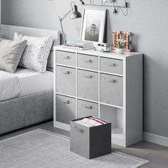 a bedroom with gray walls and white furniture