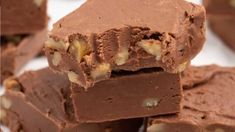 a pile of chocolate fudges with nuts on top and one cut in half