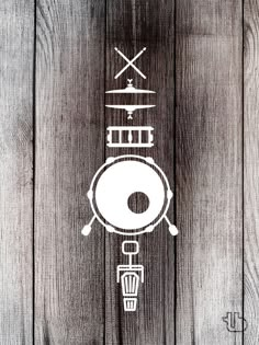 a drawing of a drum on top of a wooden wall with two crossed swords above it