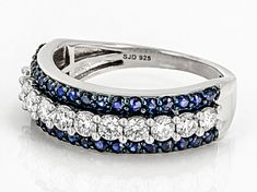 Moissanite Fire(R) .72ctw diamond equivalent weight round and .65ctw round blue sapphire, Platineve(R) ring. Blue rhodium settings. Measures 1/4" L x 116" W and is not sizeable. Actual moissanite weight is .60ctw. Fine Jewelry Round Sapphire Ring With Channel Set, Fine Jewelry Sapphire Ring With Channel Set, Channel Set Sapphire Diamond Ring, Round Sapphire Color Diamond Ring Channel Set, Round Sapphire Diamond Ring With Channel Set, Channel Set Sapphire Ring, Ring Blue, Blue Sapphire, Sapphire