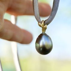 Gorgeous large grey Tahitian pearl set in 18 karat gold and strung on naturally dyed silk. There is no clasp so that you can wear it at any length, or around your wrist, or you can slide off the pendant and put it on your favourite chain. The total length of the drop pendant is 1 inch. The pearl measures approximately 12 x 16mm. Available for immediate shipping from Sweden. Delivery 1+2 weeks depending on your location. For free shipping select AIRMAIL at checkout. Tahitian Pearl Pendant, Reflecting Light, Dyed Silk, Pearl Set, Tahitian Pearls, Silk Dyeing, Naturally Dyed, Drop Pendant, Pearl Pendant