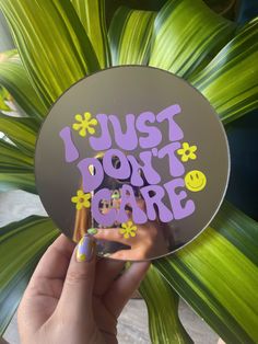 a person holding up a sticker with the words i just don't care