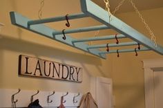 there is a sign that says laundry hanging from the ceiling