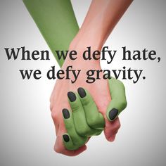 two hands holding each other with the caption when we defy hate, we defy gravity