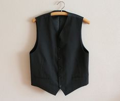 "Mens Vest Black Vest Black Men's Vest Gentlemen's Vest Steampunk Mens Waistcoat Black Fitted Edwardian Victorian Renaissance Steampunk Baroque Label size: B 46 Measurements (lying flat): Length(back): 22\"/ 56 cm Chest: 19 3/4\"/ 50 cm Waist: 19.5\"/ 49.5 cm Condition: great Vintage Condition Material: 67%polyester,33%viscose Please check measurements to insure a proper fit. Remember to allow yourself some extra room for movement. You can compare these with something from your closet that fits Fitted Black Vest For Costume, Black Fitted Steampunk Vest, Fitted Alternative Winter Vest, Fitted Alternative Style Winter Vest, Alternative Fitted Winter Vest, Alternative Style Fitted Winter Vest, Winter Alternative Fitted Vest, Gothic Black Vest For Costume, Black Gothic Costume Vest