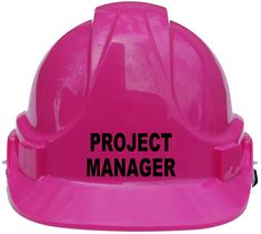 a pink hard hat with the word the boss on it