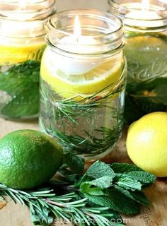 three mason jars filled with lemons and herbs